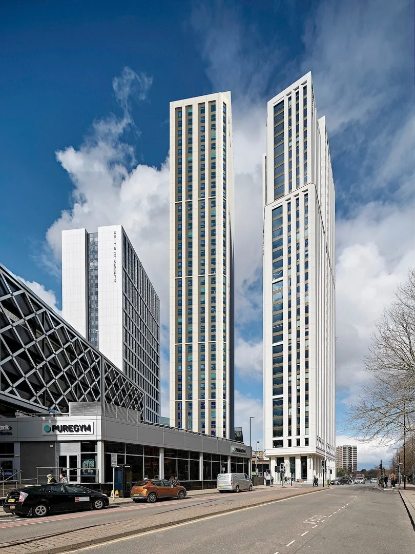 Cirrus Point tower and surrounding buildings in Leeds under a blue sky.