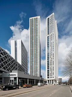 Cirrus Point tower and surrounding buildings in Leeds under a blue sky.
