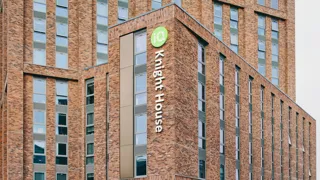 Knight House brick facade with projecting windows and building signage.
